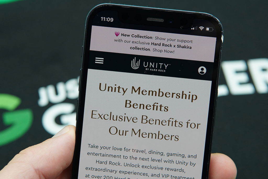 Photo of Patrik Lidin holding an iPhone with the Hard Rock Unity loyalty program loaded.