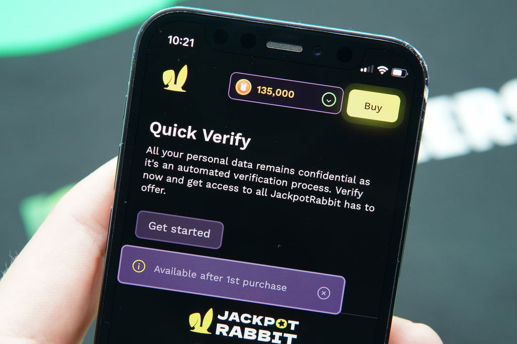 Patrik Lidin holding an iPhone with the JackpotRabbit casino KYC page loaded on the webpage.