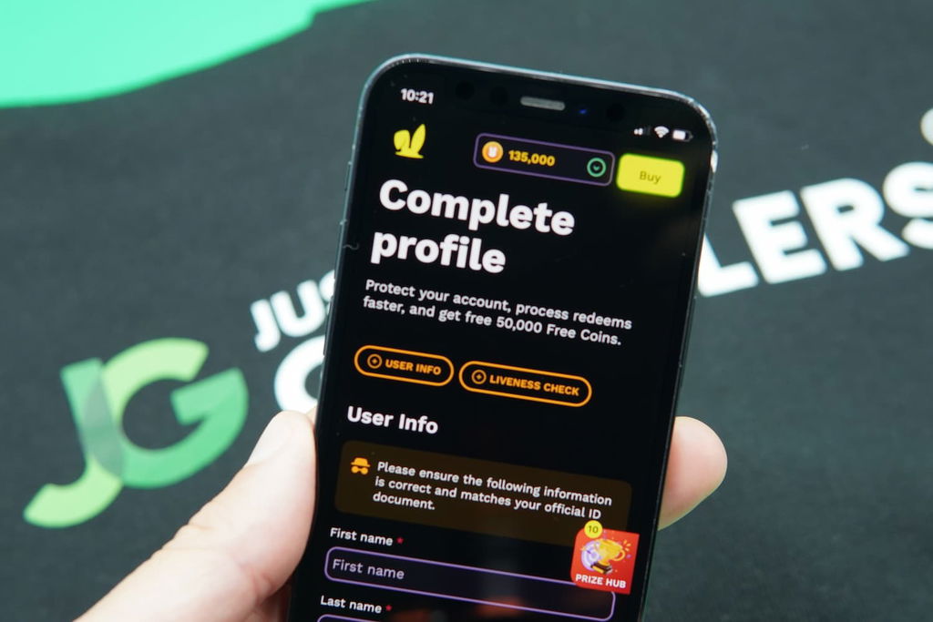 Patrik Lidin holding an iPhone with the JackpotRabbit casino Redemptions Page loaded on the webpage.