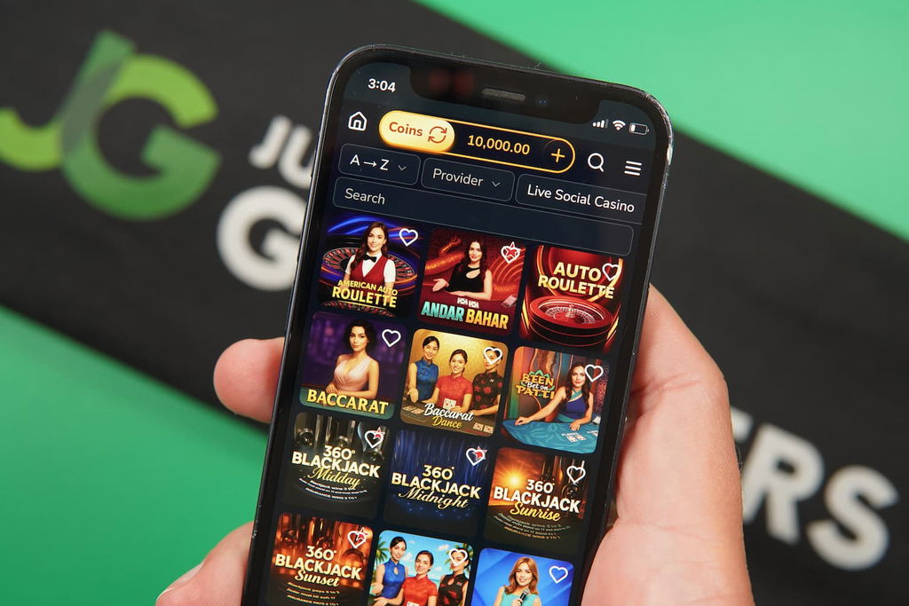 Patrik Lidin holding an iPhone with the Jumbo88 casino game library page loaded on the webpage.