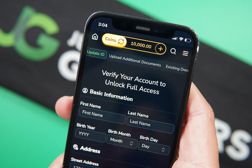 Patrik Lidin holding an iPhone with the Jumbo88 casino KYC page loaded on the webpage.
