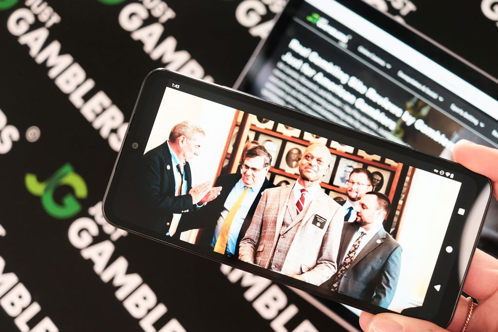 Photo of an iPhone showing a photograph of Senator Craig Hickman in Maine who is involved with the sweepstakes casino ban discussions.