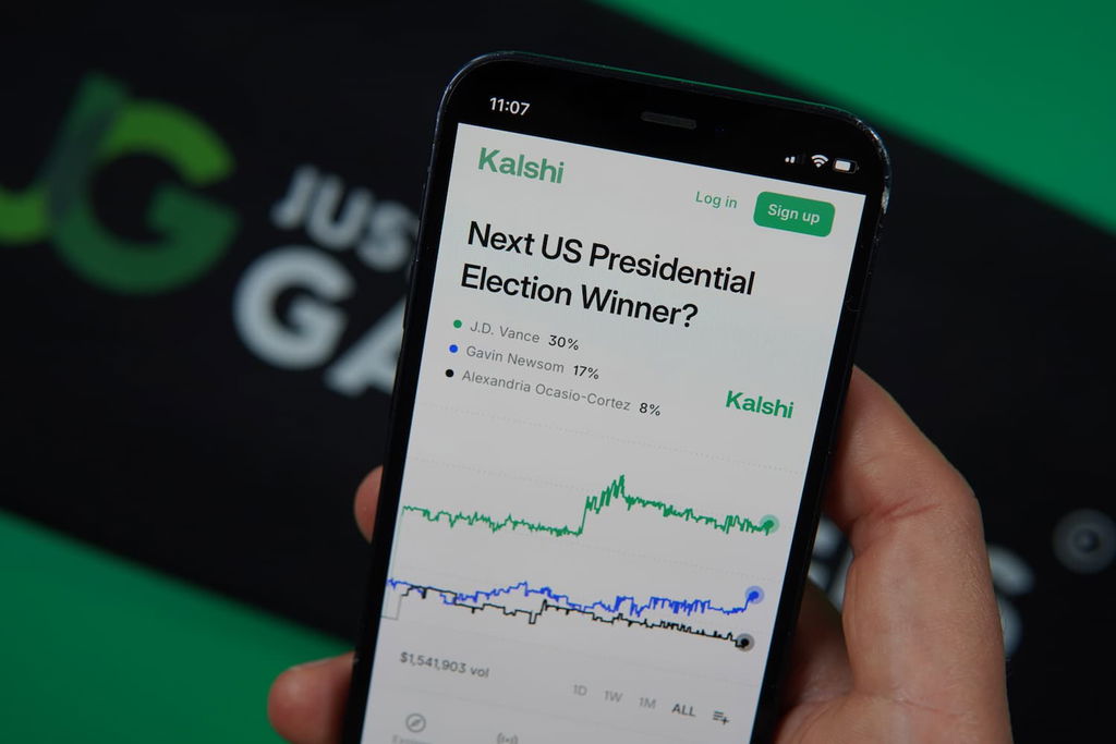 Photo of Patrik Lidin holding an iPhone with a prediction market loaded on the screen.
