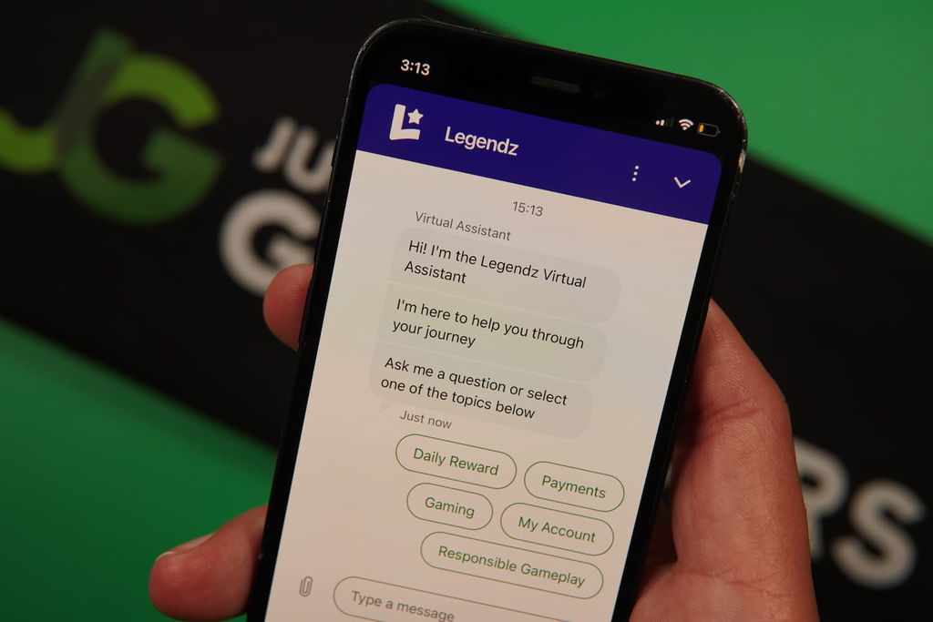 Patrik Lidin holding an iPhone with the Legendz casino Customer Support page loaded on the webpage.