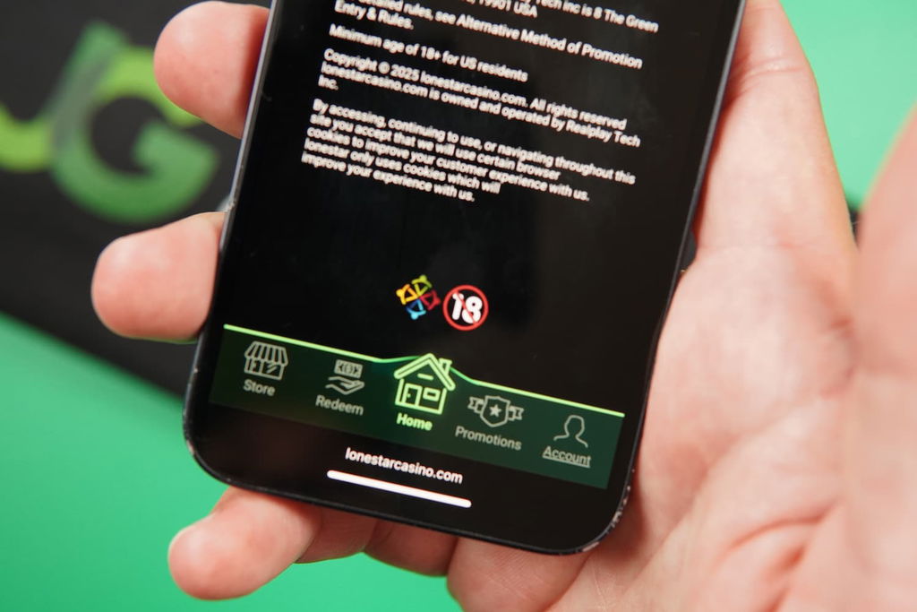 Patrik Lidin holding an iPhone with the LoneStar casino age limit page loaded on the webpage.