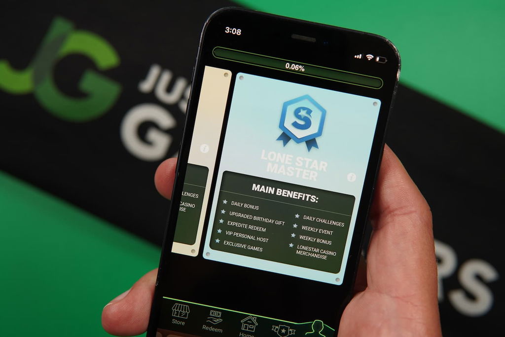 Patrik Lidin holding an iPhone with the LoneStar casino loyalty program page loaded on the webpage.