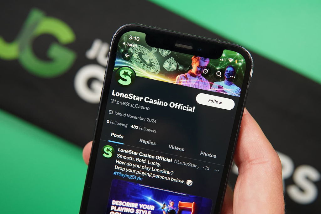 Patrik Lidin holding an iPhone with the LoneStar casino trust X page loaded on the webpage.