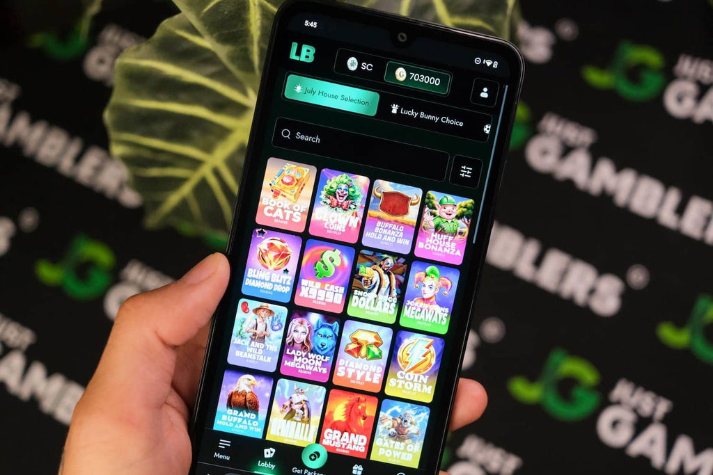 Angela Zillich holding an Android Phone with Lucky Bunny casino Games page loaded on the webpage.