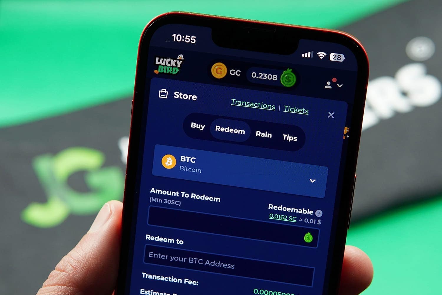 Photo of Patrik Lidin holding an iPhone with LuckyBird.io payout page loaded.