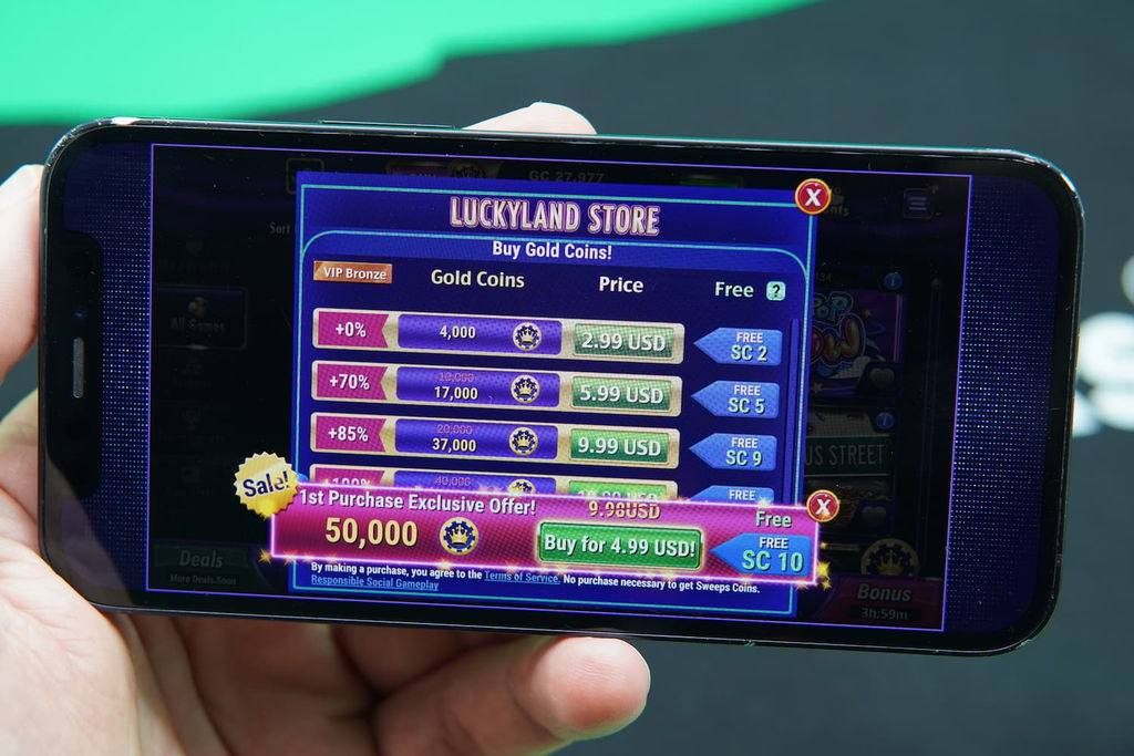Patrik Lidin holding an iPhone with the LuckyLand casino coin purchase page loaded on the webpage.