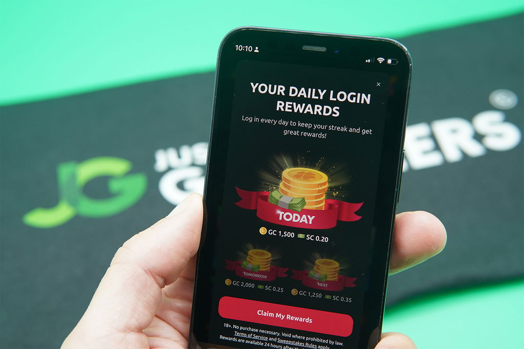 Patrik Lidin holding an iPhone with the McLuck rewards page loaded on the webpage.