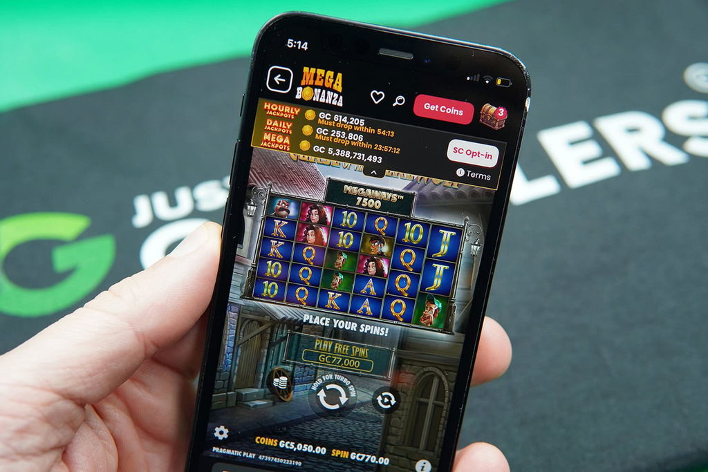 Patrik Lidin holding an iPhone with Mega Bonanza casino game Curse of the Werewolf showing.