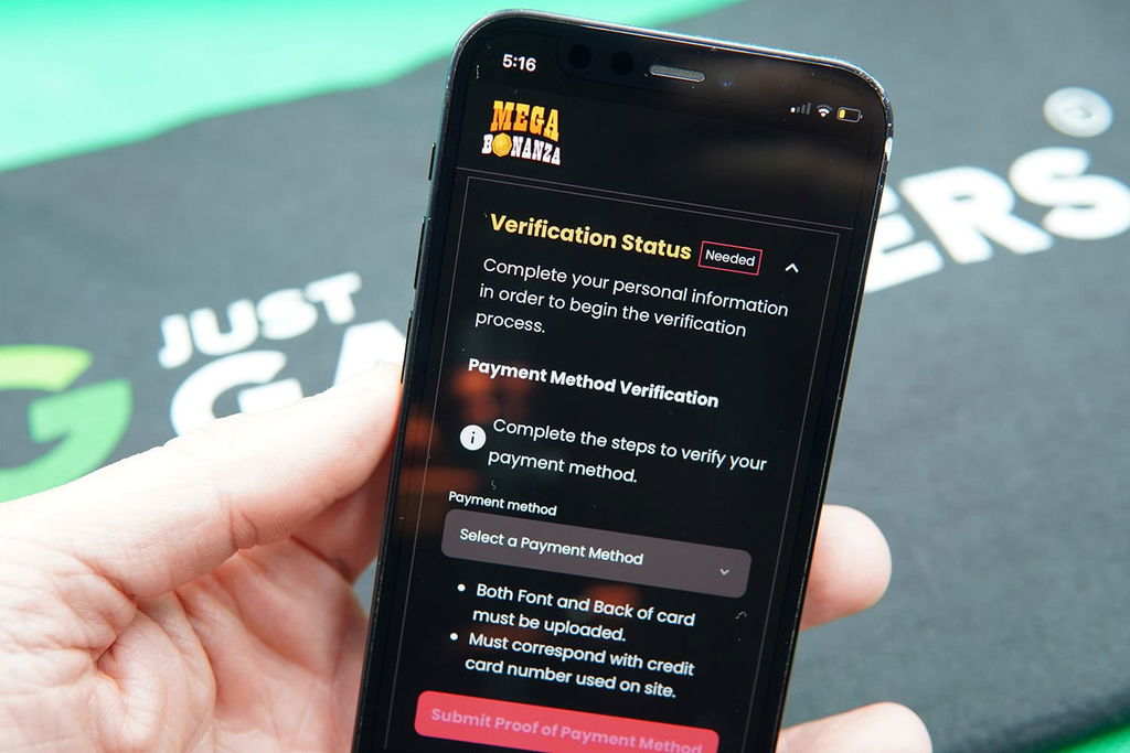 Patrik Lidin holding an iPhone showing the Mega Bonanza KYC requirements.