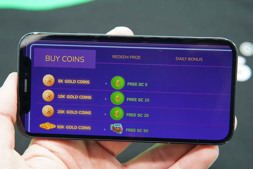 Patrik Lidin holding an iPhone with the Milky Star Slots casino coin purchase page loaded on the webpage.