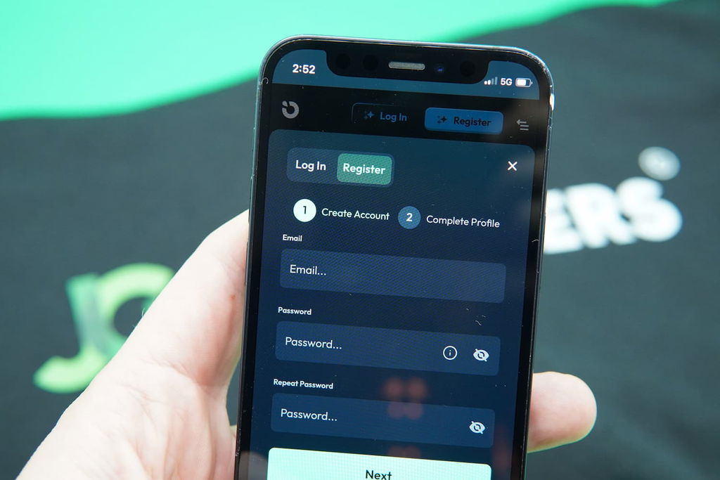 Patrik Lidin holding an iPhone with the Moonspin registration page loaded on the webpage.