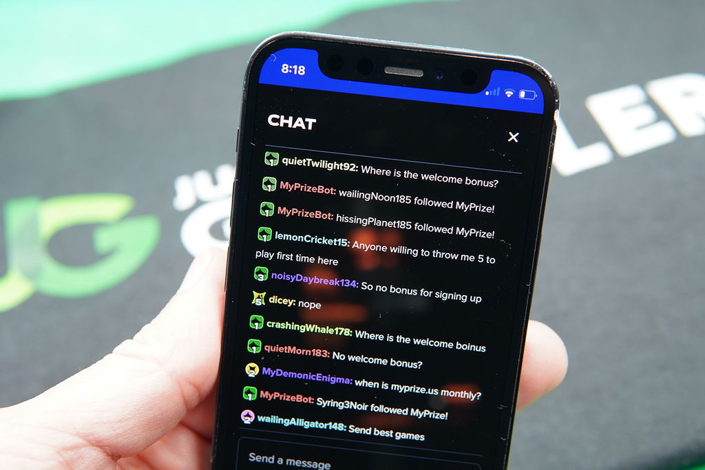 Patrik Lidin holding an iPhone while using the MyPrize US community chat.