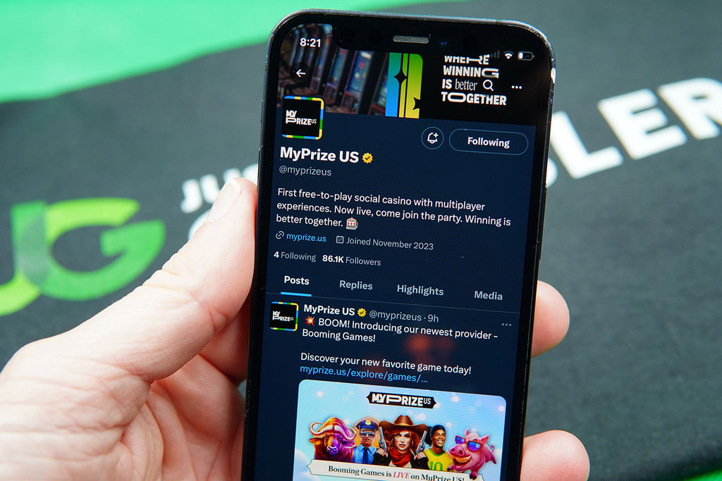 Patrik Lidin holding an iPhone with the MyPrize X account.