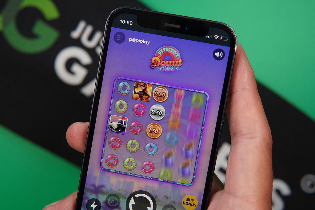 Photo of Patrik Lidin holding an iPhone showing a game that is not a live casino game.