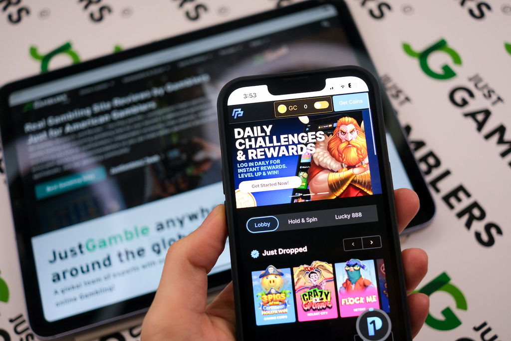 Angela Zillich holding an iPhone with the PeakPlay casino landing page loaded on the webpage.