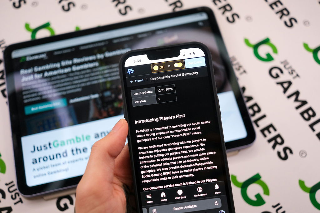 Angela Zillich holding an iPhone with the PeakPlay casino Responsible Gaming tools page loaded on the webpage.