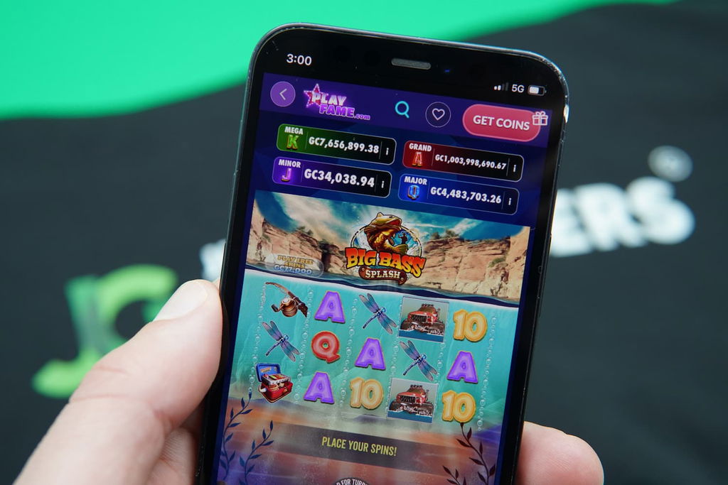 Patrik Lidin holding an iPhone with the PlayFame in-game mobile page loaded on the webpage.