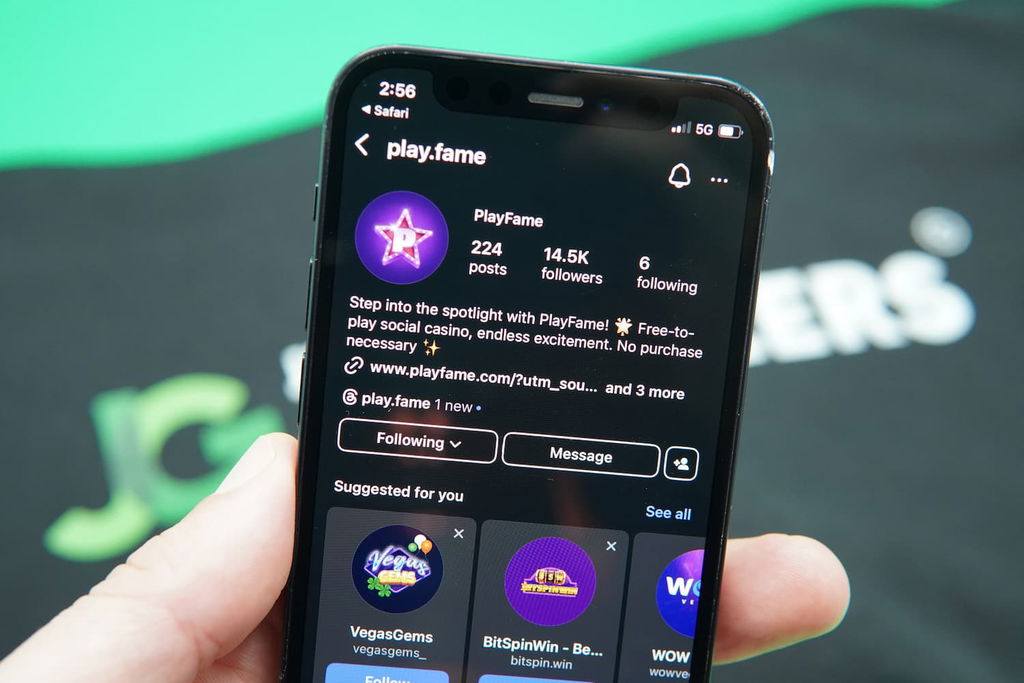 Patrik Lidin holding an iPhone with the PlayFame Instagram page loaded on the webpage.