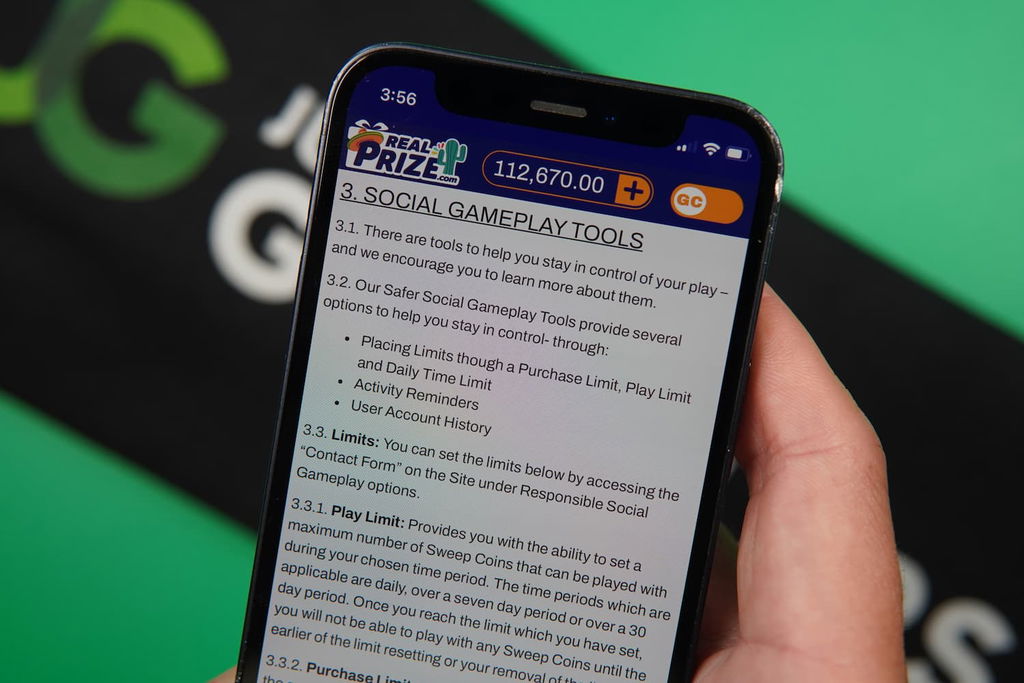 Patrik Lidin holding an iPhone with the RealPrize casino responsible gaming page loaded on the webpage.