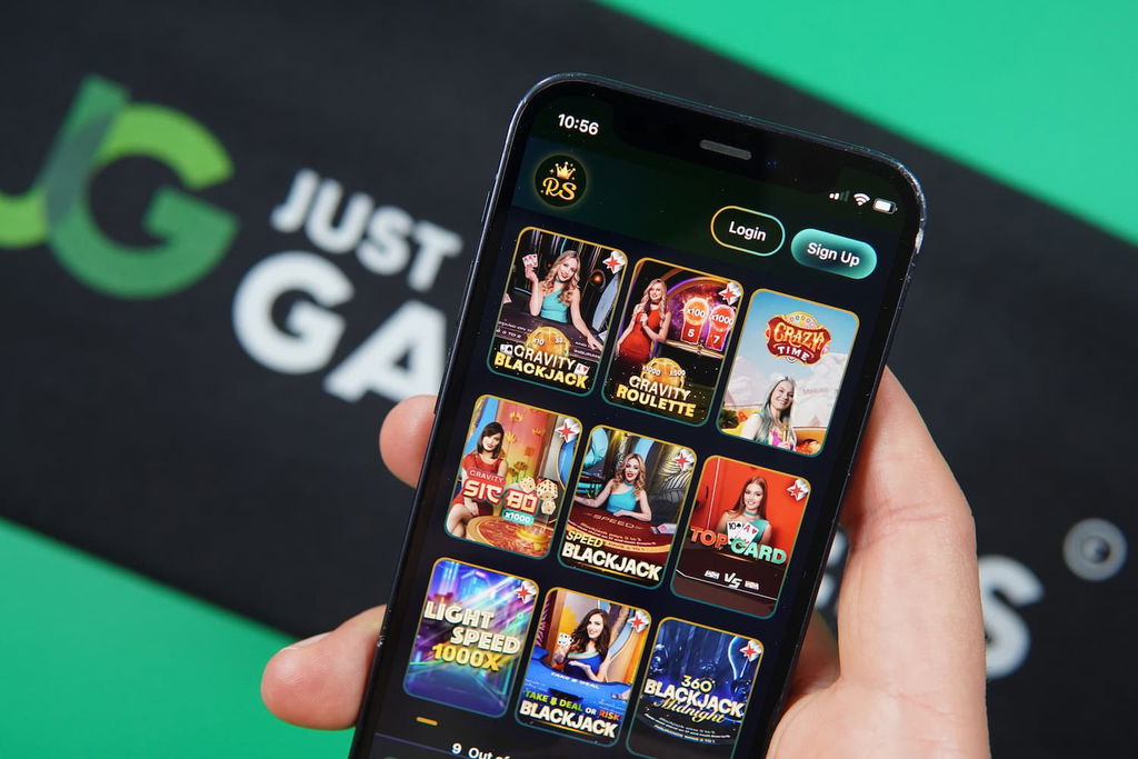 Patrik Lidin holding an iPhone with the RichSweeps casino live dealer games page loaded on the webpage.