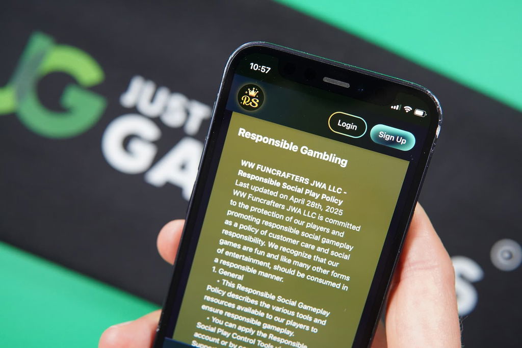Patrik Lidin holding an iPhone with the RichSweeps casino responsible gaming page loaded on the webpage.