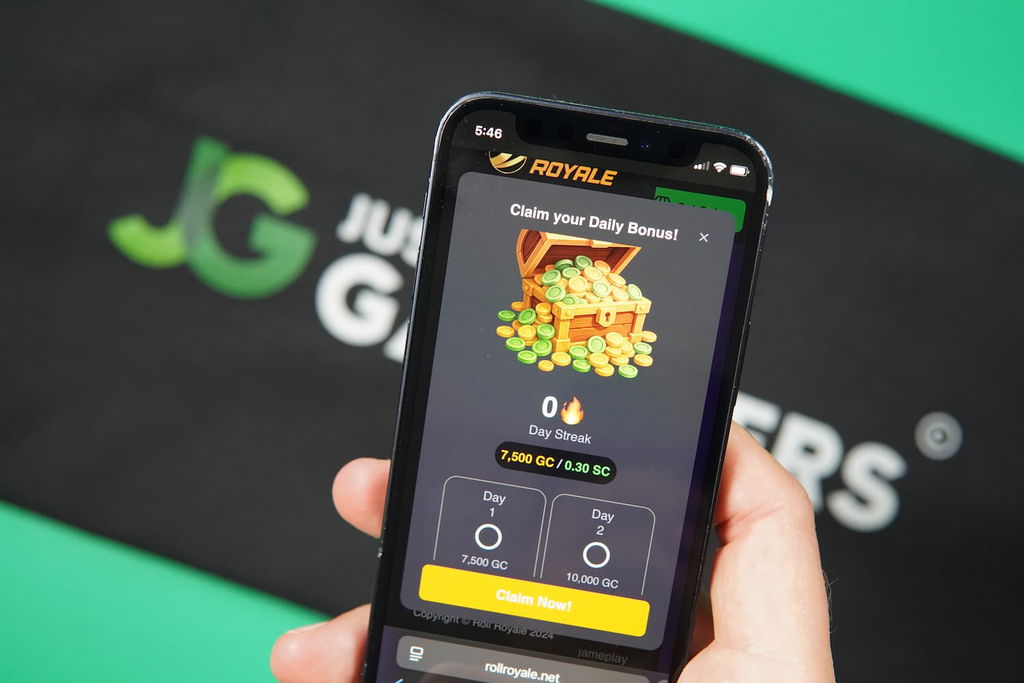Patrik Lidin holding an iPhone with the Roll Royale casino promotions page loaded on the webpage.
