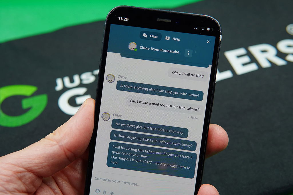 Patrik Lidin holding an iPhone while using the Runestake customer support.
