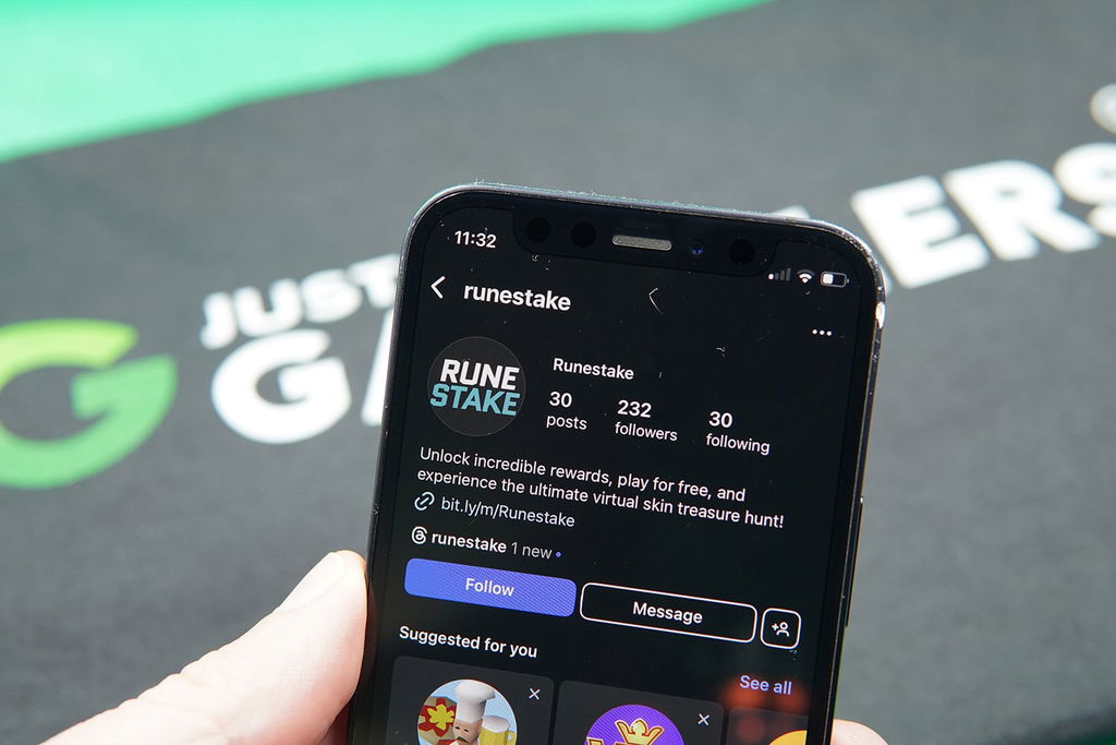 Patrik Lidin holding an iPhone with the Runestake Instagram account.