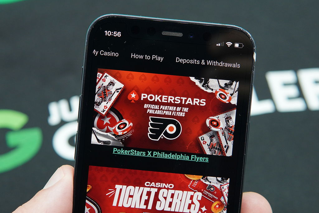 Photo of Patrik Lidin holding an iPhone with a temporary seasonal NJ online casino bonus showing.