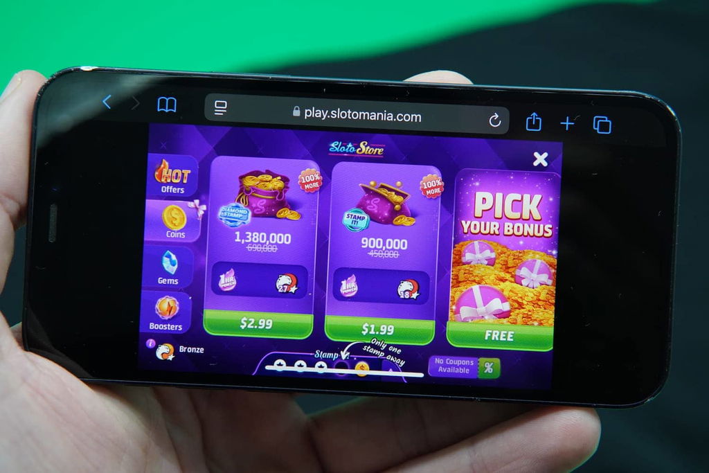 Patrik Lidin holding an iPhone with the Slotomania casino coin purchase page loaded on the webpage.