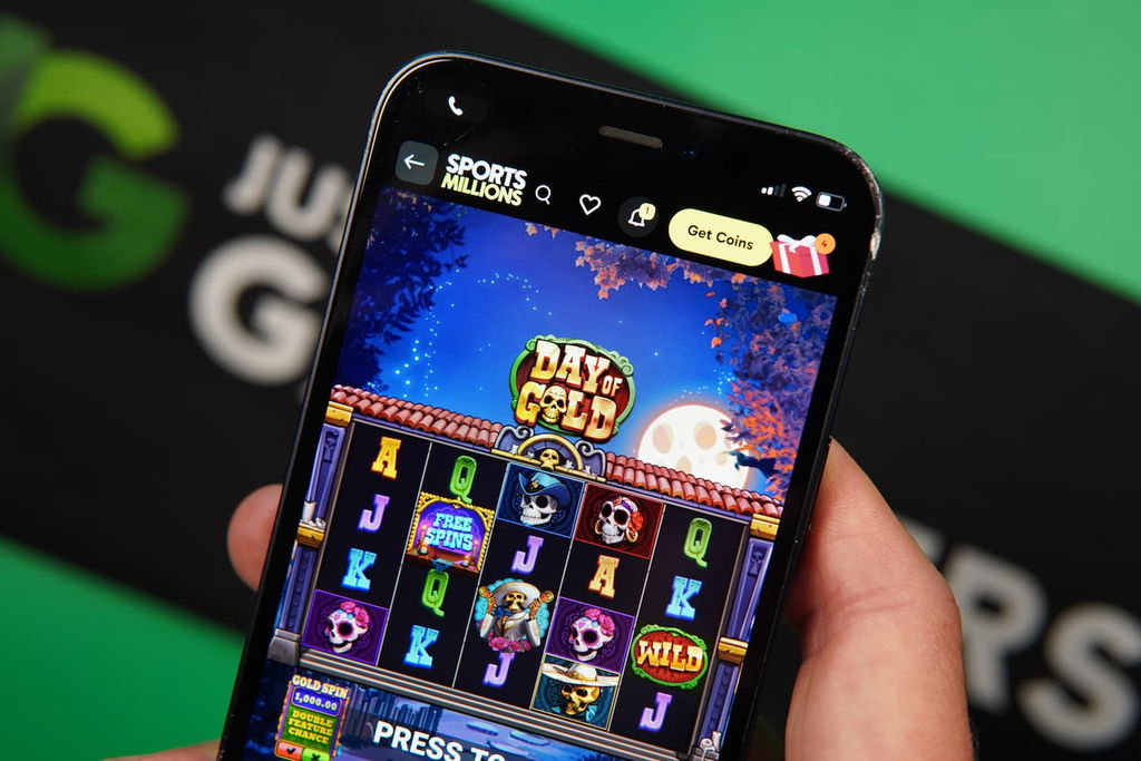 Patrik Lidin holding an iPhone with the Sports Millions sweepstakes casino mobile in-game page loaded on the webpage.