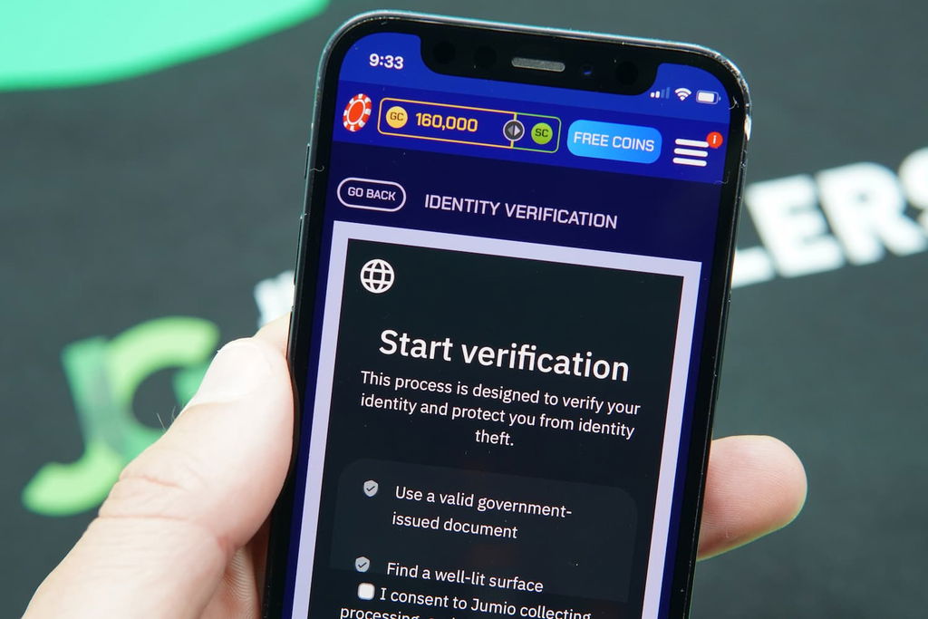 Patrik Lidin holding an iPhone with the Sportzino casino KYC page loaded on the webpage.