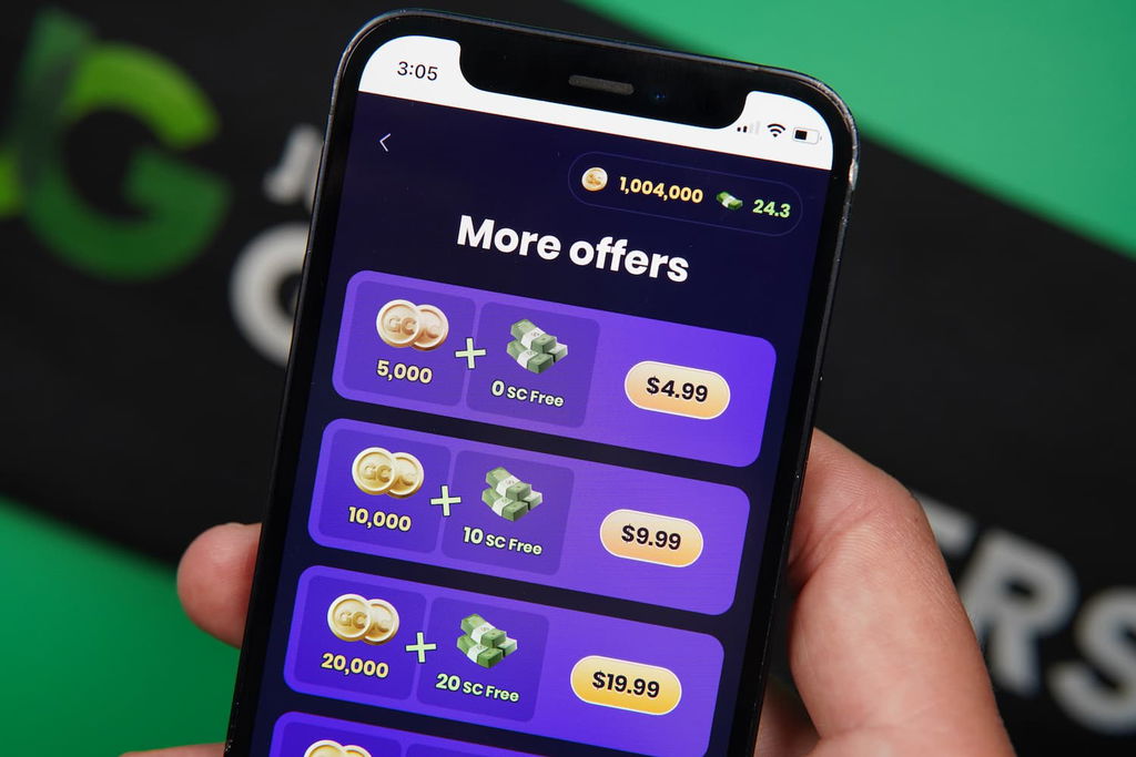 Patrik Lidin holding an iPhone with the Spree casino purchases page loaded on the webpage.