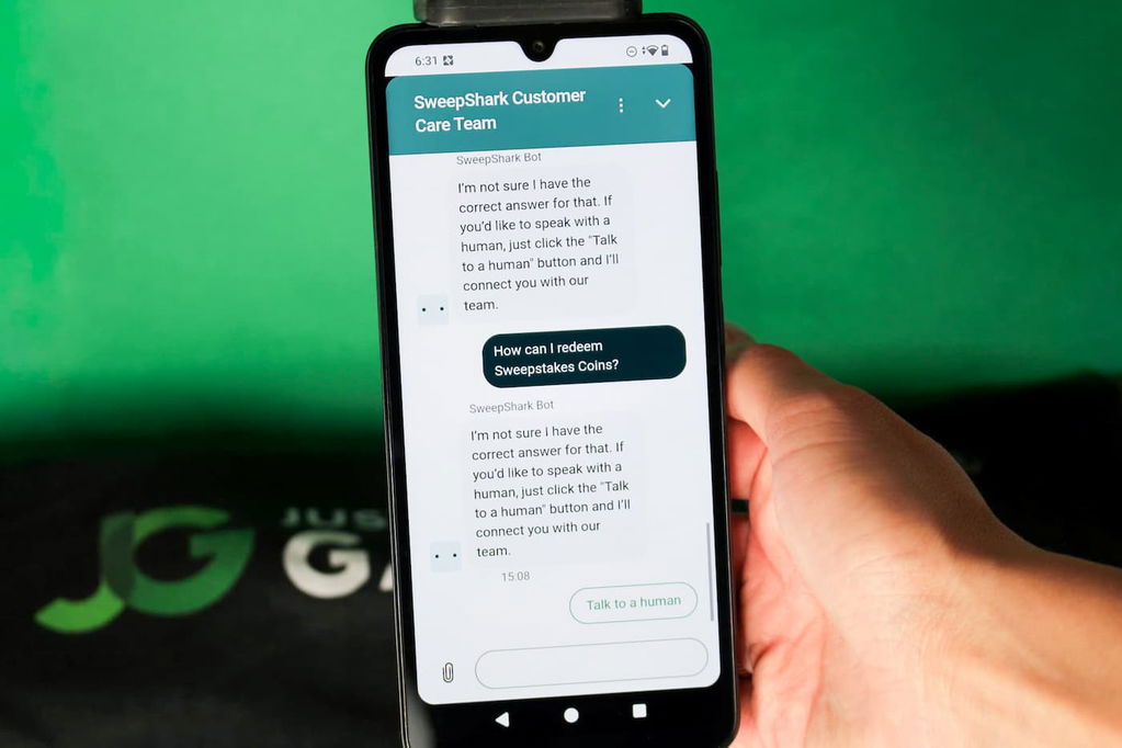 Angela Zillich holding an iPhone with the SweepShark casino Customer Support page loaded on the webpage.