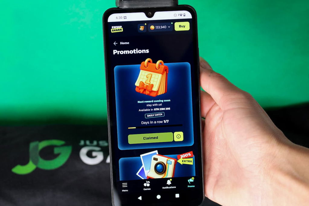 Angela Zillich holding an iPhone with the SweepShark casino Promotions page loaded on the webpage.