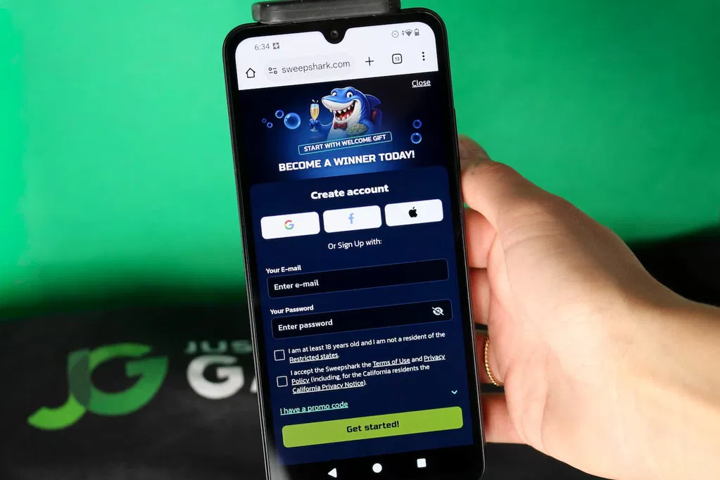Angela Zillich holding an iPhone with the SweepShark casino registration page loaded on the webpage.