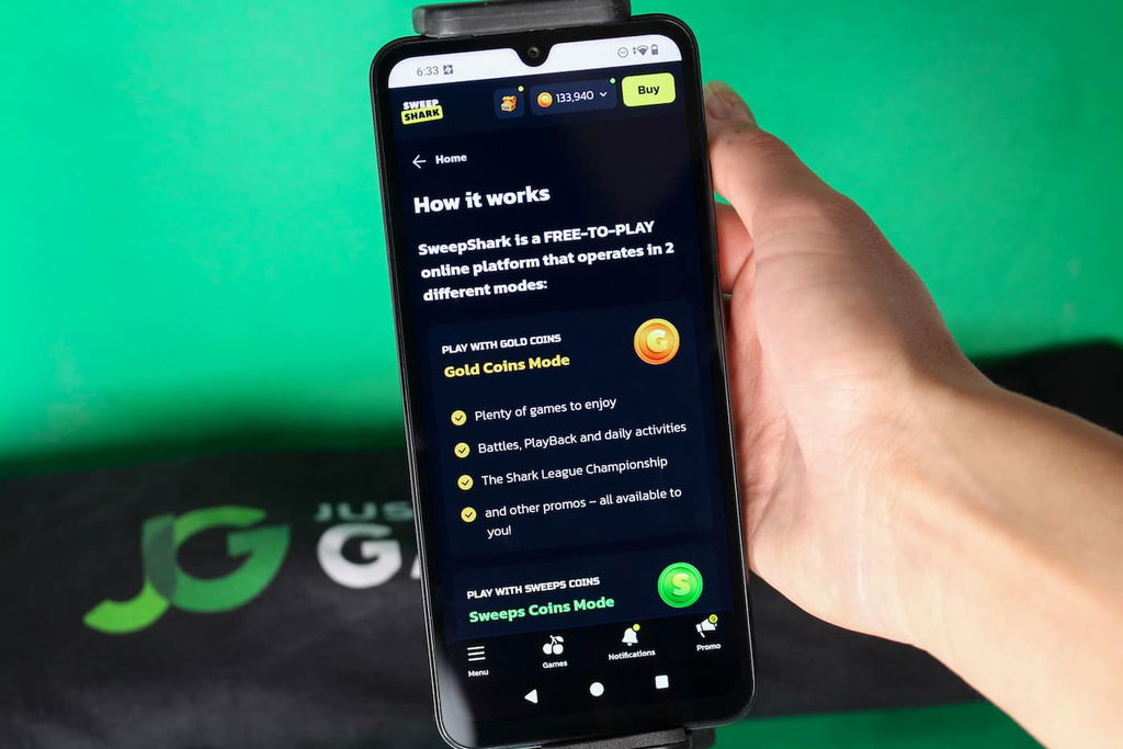 Angela Zillich holding an iPhone with the SweepShark casino usability How it Works page loaded on the webpage.