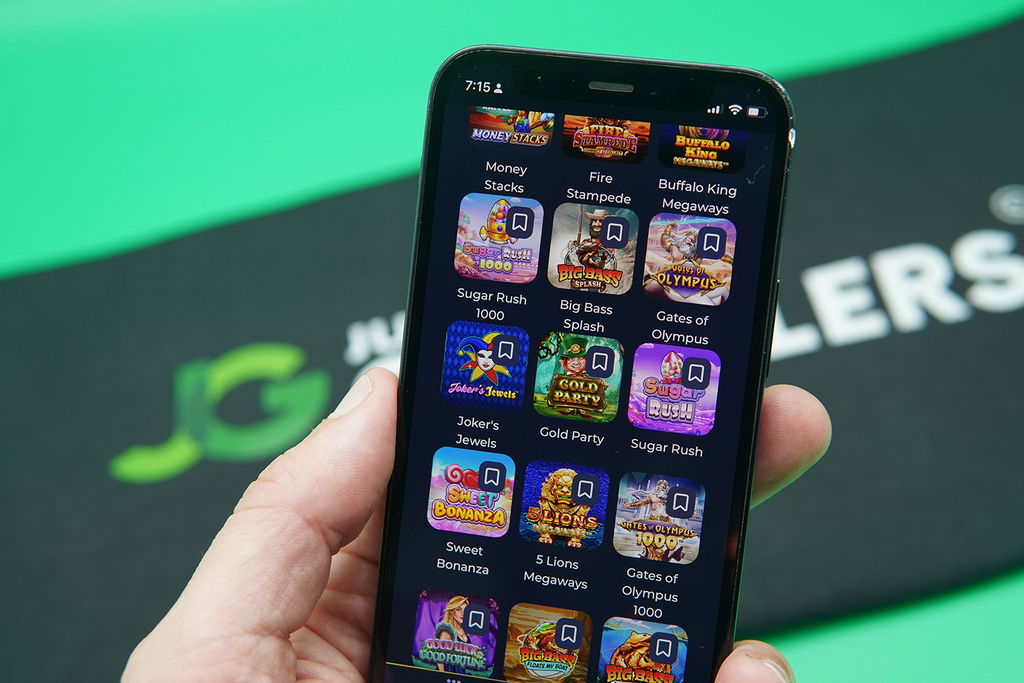 Patrik Lidin holding an iPhone with Sweeptastic game library showing.