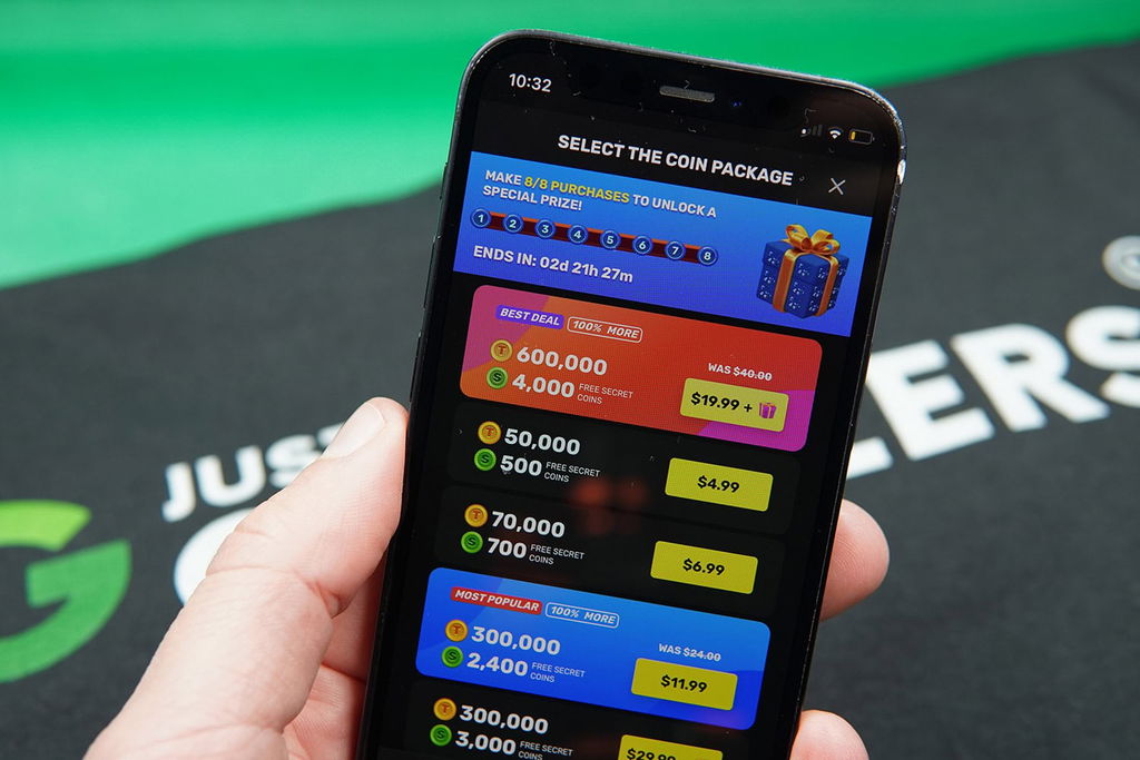Patrik Lidin holding an iPhone showing offers for TaoFortune coin packages.
