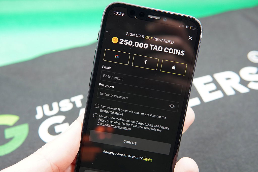 Patrik Lidin holding an iPhone showing the TaoFortune registration process.