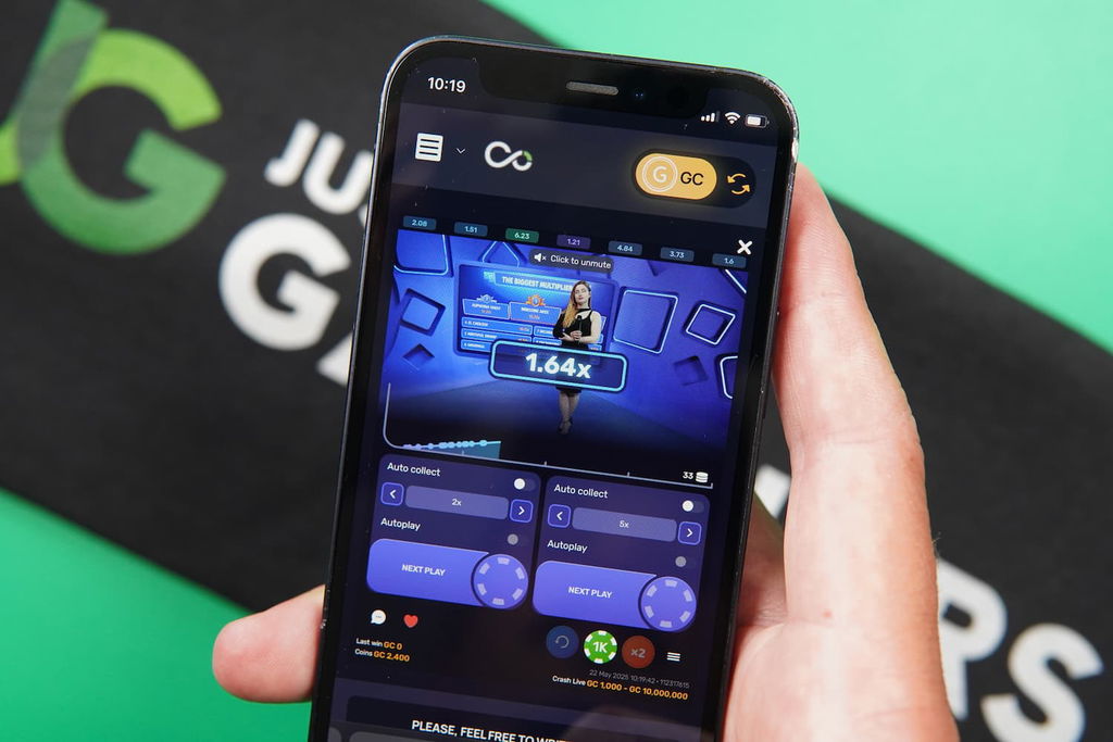Patrik Lidin holding an iPhone with the Vegas Coins casino game section game page loaded on the webpage.