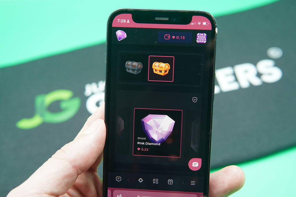 Patrik Lidin holding an iPhone with the Vegas Gems rewards page loaded on the webpage.