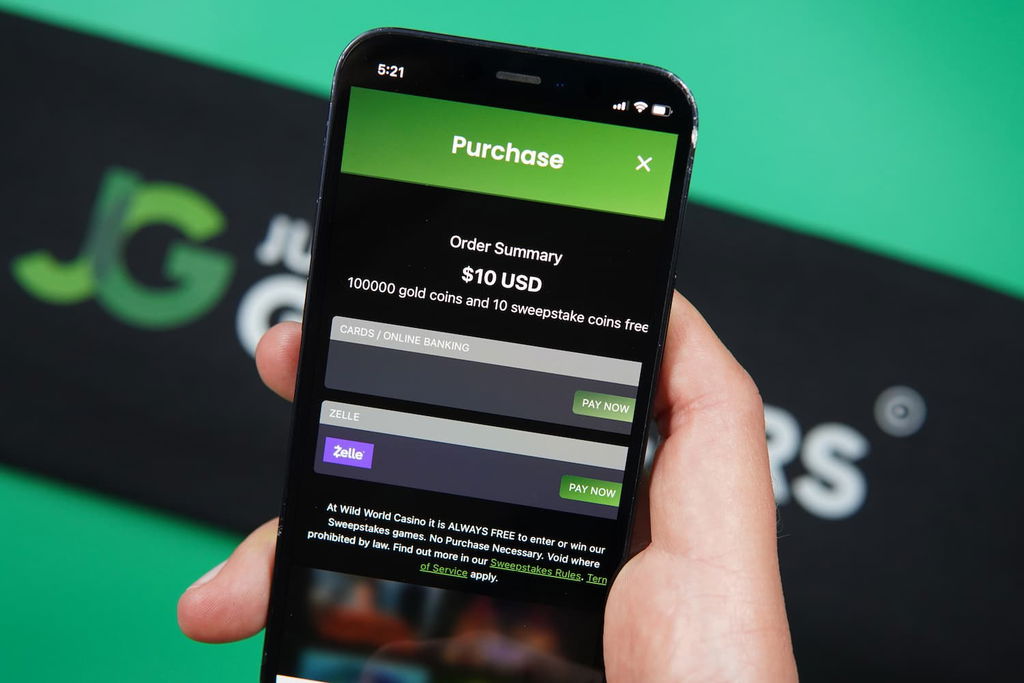 Patrik Lidin holding an iPhone with the Wild World Casino mobile payments page loaded on the webpage.