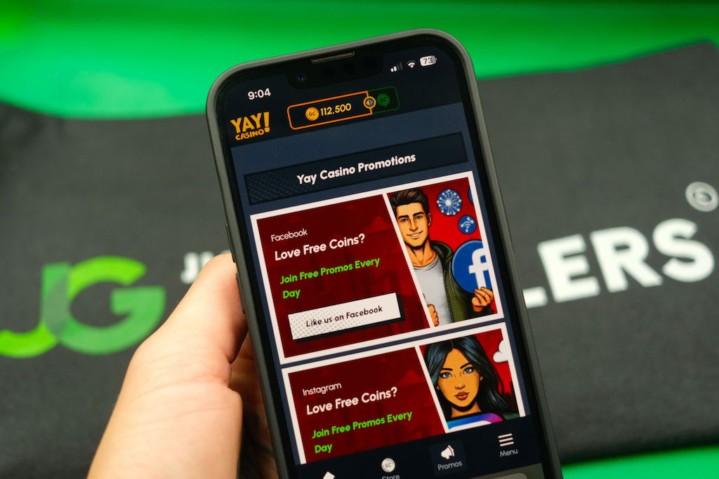 Patrik Lidin holding an iPhone with the Yay casino promotions page loaded on the webpage.