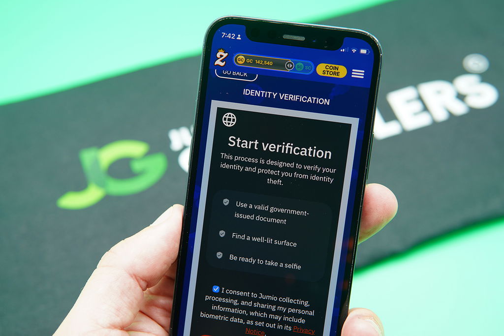 Patrik Lidin holding an iPhone showing the Zula Casino KYC process.
