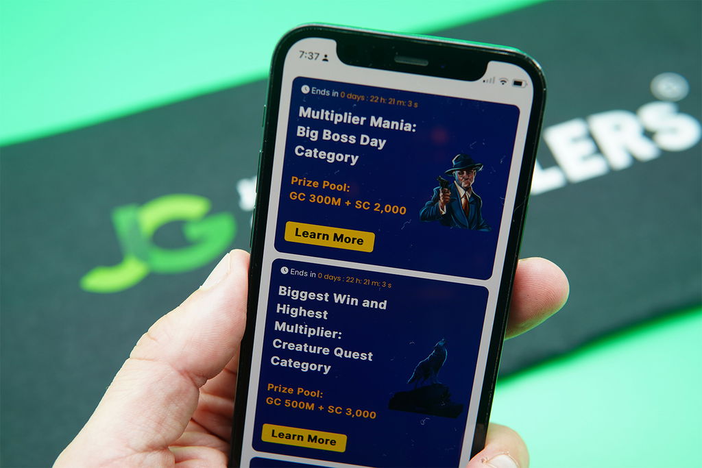 Patrik Lidin holding an iPhone with the Zula Casino rewards page loaded on the webpage.